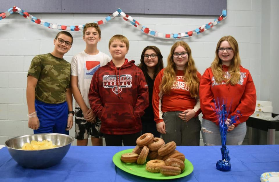 Middle School students visited with veterans in the school cafeteria following the ceremony, and offered baked goods and coffee to those in attendance