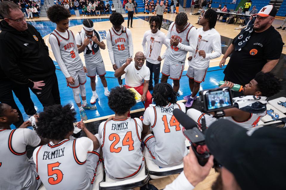 North boys' basketball coach Al Pettway tells the team to remember for whom they are playing during a timeout against Xaverian during a Division 1 state semifinal Wednesday at UMass-Boston. Pettway and the entire North team have dedicated this season to former teamate Carl-Hens Beliard, who was tragically killed prior to this season.