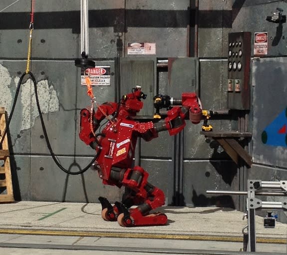 Team Tartan Rescue's robot, CHIMP, wields a drill during one of the tasks on Dec. 21, 2013 at the DARPA Robotics Challenge.