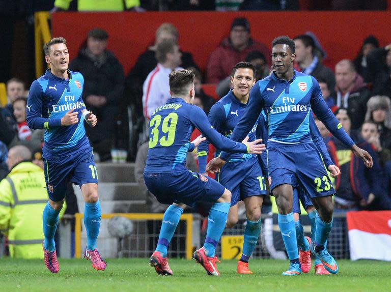 Arsenal's striker Danny Welbeck (R) celebrates with teammates after scoring their second goal during the FA Cup quarter-final football match between against Manchester United at Old Trafford on March 9, 2015