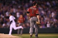 Jul 11, 2018; Denver, CO, USA; Arizona Diamondbacks relief pitcher Daniel Descalso (3) watches as Colorado Rockies right fielder Carlos Gonzalez (5) (background) rounds the bases in the fourth inning at Coors Field. Mandatory Credit: Ron Chenoy-USA TODAY Sports