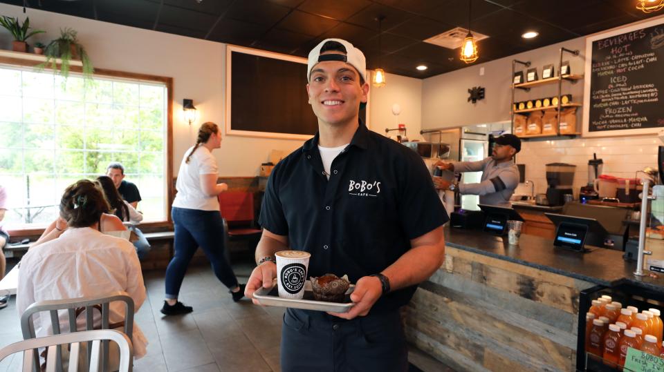 Owner Craig Bernardi is pictured with a cappuccino and a gluten free chocolate chip muffin, at Bobo's Cafe on Route 6 in Baldwin Place, photographed July 9, 2021. 