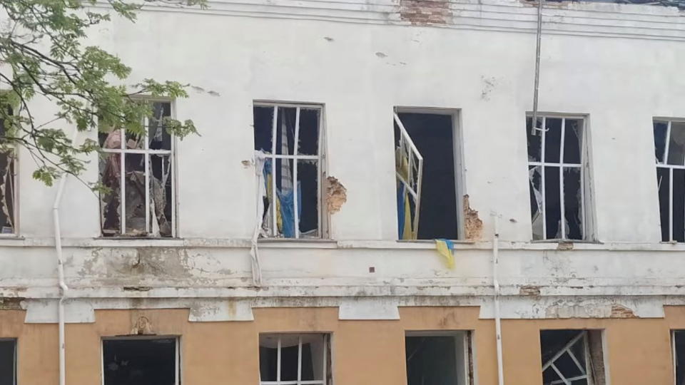 Ukrainian flags hang in the blown-out windows of a school destroyed by shelling, during Russia's invasion of Ukraine, in Novhorod-Siverskyi, Chernihiv Region, May 12, 2022. State Emergency Service of Ukraine/Handout via REUTERS THIS IMAGE HAS BEEN SUPPLIED BY A THIRD PARTY.