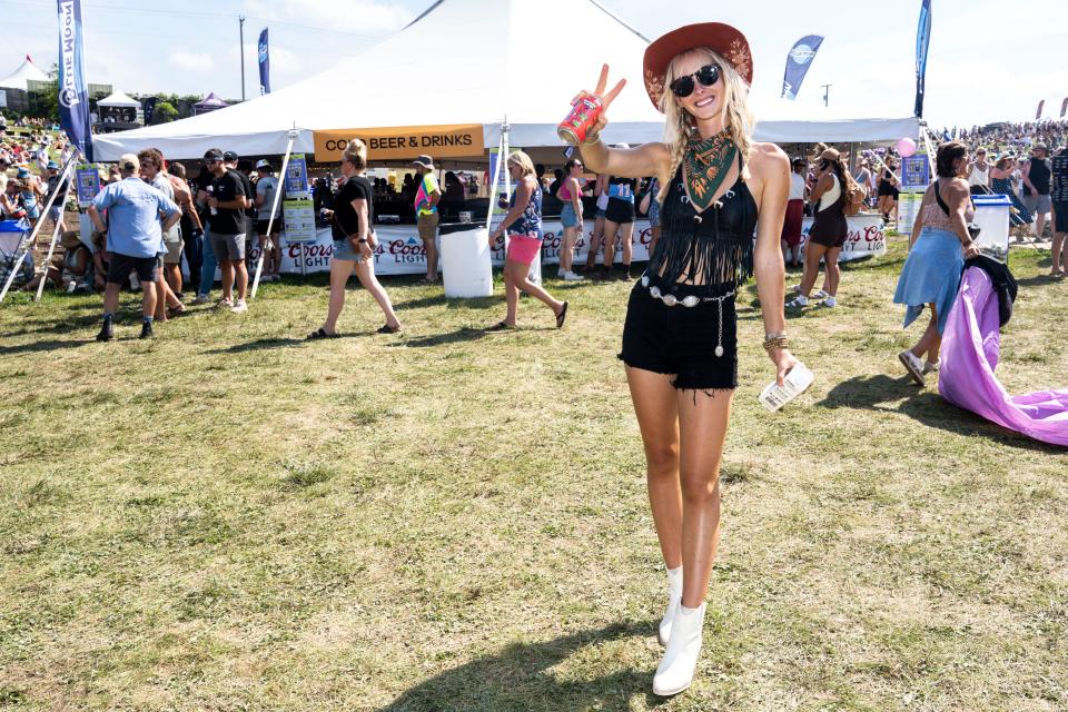 Bekka Watt of Baxter dons her mom's old top on day two of the Hinterland Music Festival in St. Charles.