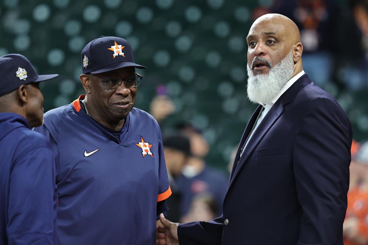 Major League Baseball Players Association executive director Tony Clark speaks with Houston Astros manager Dusty Baker before Game 2 of the 2022 World Series at Minute Maid Park.