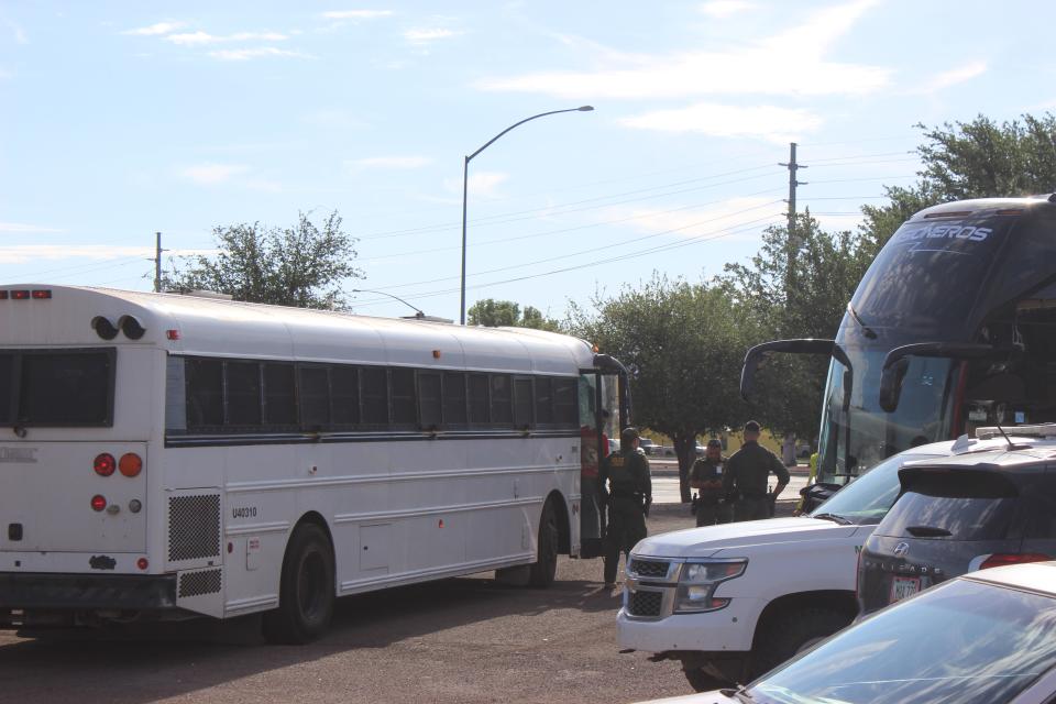 U.S. Border Patrol transfers a few dozen migrants to a state-run charter bus headed toward Phoenix from the Douglas Visitor's Center parking lot on Wednesday, May 17, 2023.