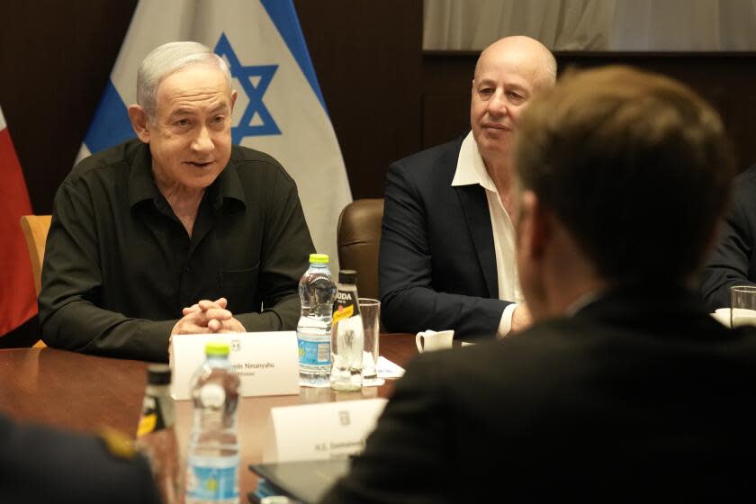 Israeli Prime Minister Benjamin Netanyahu, left, talks to French President Emmanuel Macron in Jerusalem.