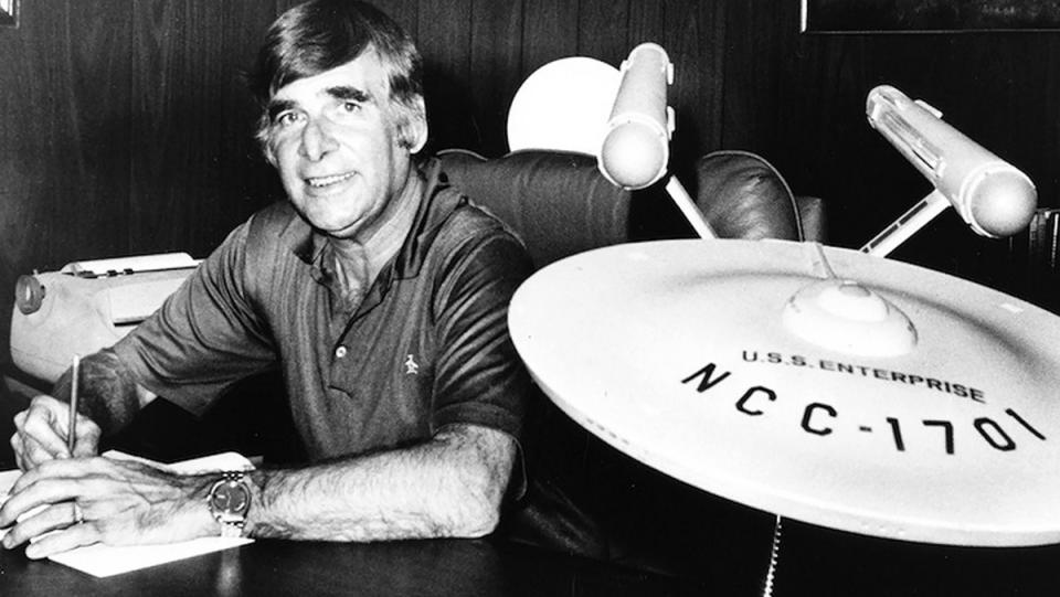 Gene Roddenberry with a model of the starship Enterprise.