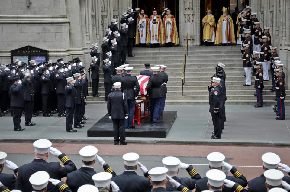 The casket of U.S. Marine Corps Staff Sergeant and FDNY Firefighter Christopher Slutman, center, arrives for his funeral service at St. Thomas Episcopal Church, Friday April 26, 2019, in New York. The father of three died April 8 near Bagram Airfield U.S military base in Afghanistan. (AP Photo/Bebeto Matthews)