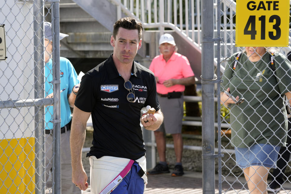 Simon Pagenaud, of France, walks to his garage during auto race testing for the upcoming Rolex 24 hour race at Daytona International Speedway, Friday, Jan. 20, 2023, in Daytona Beach, Fla. (AP Photo/John Raoux)
