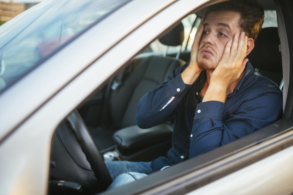 A man is frustrated and stuck in a traffic jam