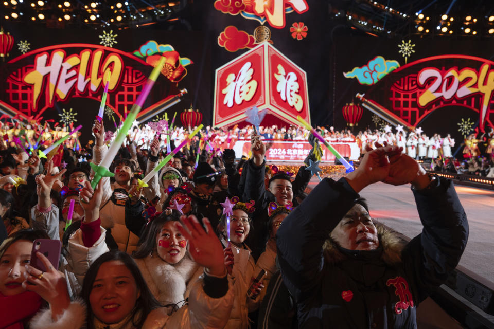 Revelers ring in the new year after a countdown to 2024 in Beijing, Monday, Jan. 1, 2024. (AP Photo/Ng Han Guan)
