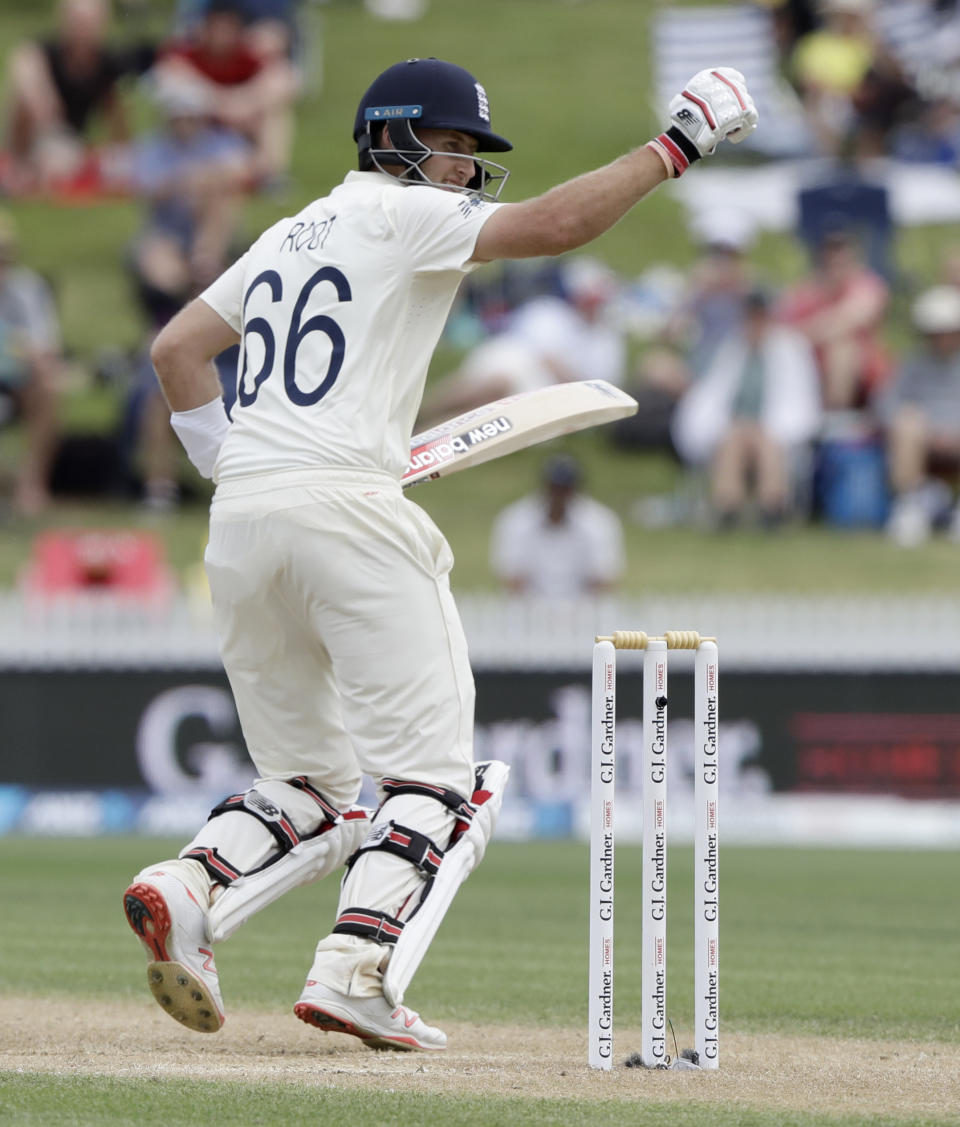 England's Joe Root celebrates as he scores century during play on day three of the second cricket test between England and New Zealand at Seddon Park in Hamilton, New Zealand, Sunday, Dec. 1, 2019. (AP Photo/Mark Baker)