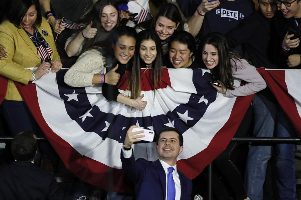 Democratic presidential candidate former South Bend, Ind., Mayor Pete Buttigieg takes a selfie with supporters after speaking at a caucus night campaign rally, Monday, Feb. 3, 2020, in Des Moines, Iowa. (AP Photo/Charlie Neibergall)