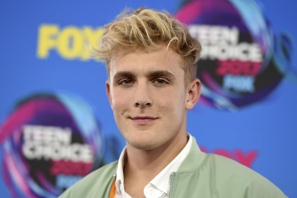 FILE - Internet personality Jake Paul arrives at the Teen Choice Awards in Los Angeles on Aug. 13, 2017. FBI agents including a SWAT team have raided the apparent home of YouTube star Jake Paul. FBI spokeswoman Laura Eimiller says agents executed a search warrant Wednesday at the Calabasas, California mansion in connection with an ongoing investigation. She could not say what the probe is about or who the target was. Helicopter video from local TV news showed agents gathering guns from the home that can frequently be seen on Paul's YouTube channel, which has over 20 million followers. (Photo by Jordan Strauss/Invision/AP, File)