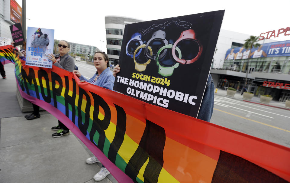 Demonstrators from a coalition of gay rights organizations, religious and political groups protest the treatment of gays in Russia, whose coastal city of Sochi hosts the 22nd Olympic Winter Games, outside the final stop of the "Road to Sochi," a traveling exhibit hosted by the U.S. Olympic Committee, at LALive in downtown Los Angeles Friday, Feb. 7, 2014. (AP Photo/Reed Saxon)