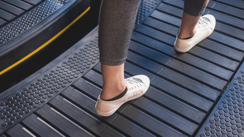 Close up of the belt on a curved treadmill with person walking on it