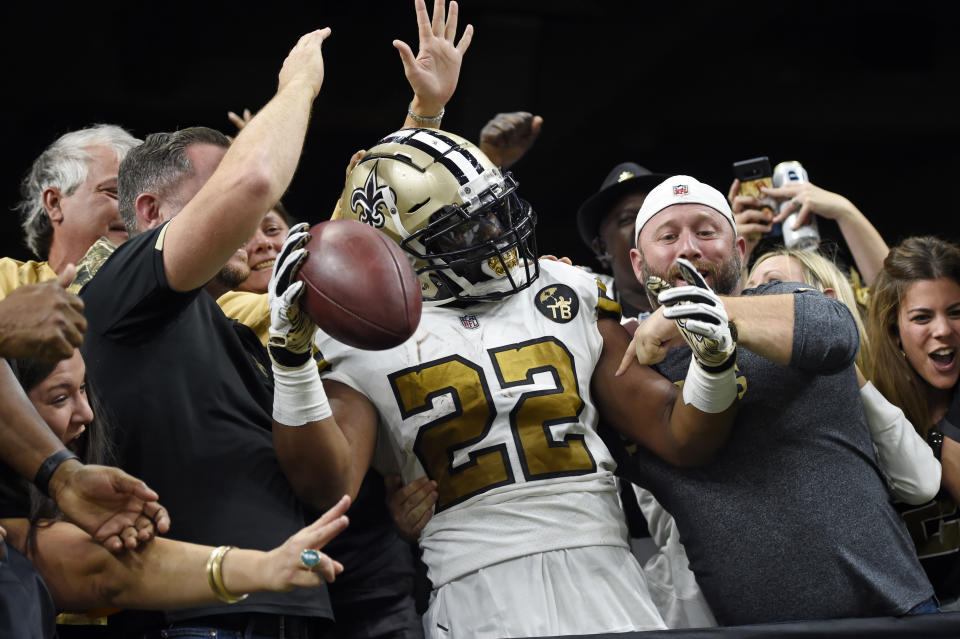 New Orleans Saints running back Mark Ingram (22) celebrates his touchdown with fans after jumping into the stands in the first half of an NFL football game against the Philadelphia Eagles in New Orleans, Sunday, Nov. 18, 2018. (AP Photo/Bill Feig)