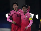 South Korea's Hwang Ui-jo, left, celebrates his goal with teammate Son Heung-min against Turkmenistan during their Asian zone Group H qualifying soccer match for the FIFA World Cup Qatar 2022 at Goyang stadium in Goyang, South Korea, Saturday, June 5, 2021. (AP Photo/Lee Jin-man)