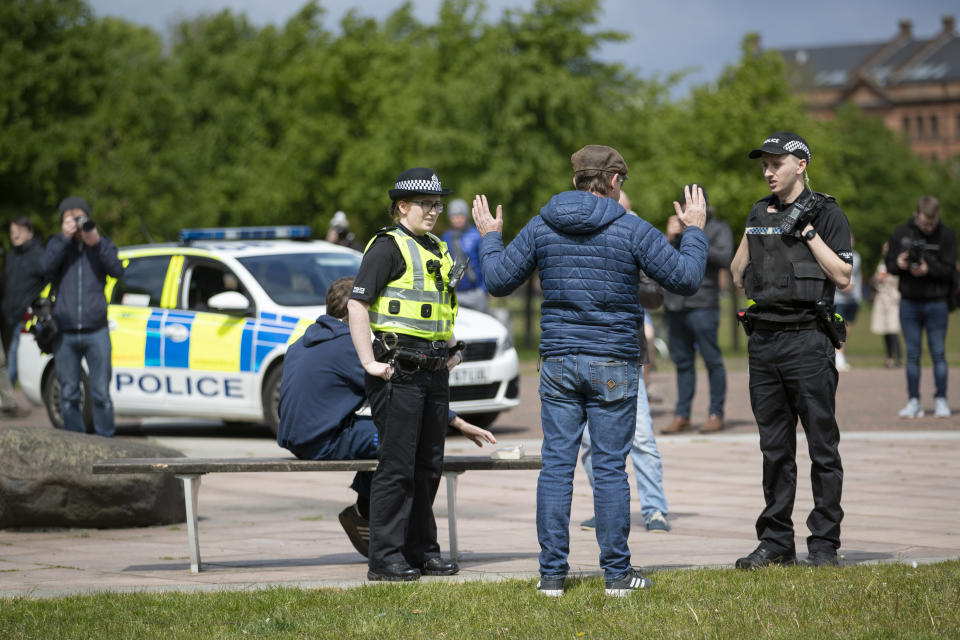 Police attend as members of the public gather in Glasgow Green to protest against the coronavirus lockdown restrictions.