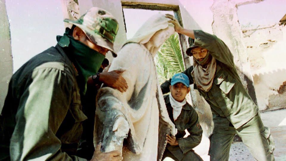 Indonesian troops remove a Virgin of Mary statue as they clean up the house of Bishop Belo in Dili September 18, 1999. Belo was among the tens of thousands forced to flee the territory as pro-Jakarta militias embarked on a wave of violence following a vote for independence from Indonesia. - Reuters