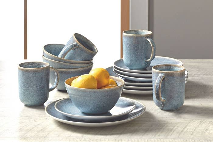 a blue set of mugs, bowls, and plates