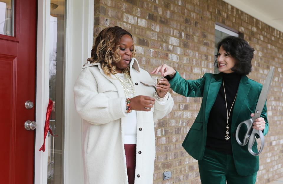 Ellen Potts, Habitat for Humanity Tuscaloosa's executive director,  gives the keys to Cassandra Jones for her new house on Pine Street Monday, Dec. 20, 2021. The build was sponsored by Alabama Power Foundation and the Holle Family Foundation. [Staff Photo/Gary Cosby Jr.]