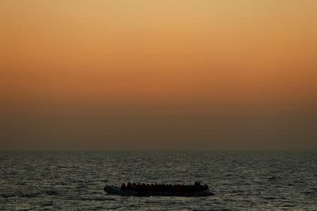 Migrants awaiting rescue on a rubber dinghy are seen from the Malta-based NGO Migrant Offshore Aid Station (MOAS) ship Phoenix in the central Mediterranean in international waters off the coast of Sabratha in Libya, April 15, 2017. REUTERS/Darrin Zammit Lupi