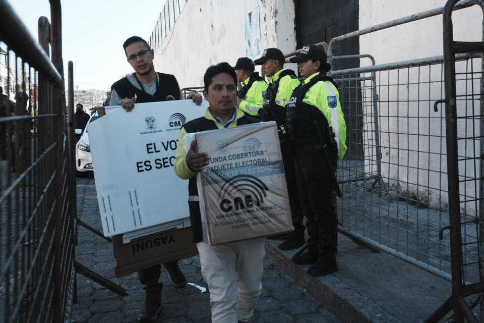 Workers from the National Electoral Council carry election materials into El Inca prison, for detainees who are not convicted but whose cases are in process, for early voting in the presidential election in Quito, Ecuador, Thursday, Aug. 17, 2023. Ecuadorians will choose a new president Aug. 20. (AP Photo/Dolores Ochoa)