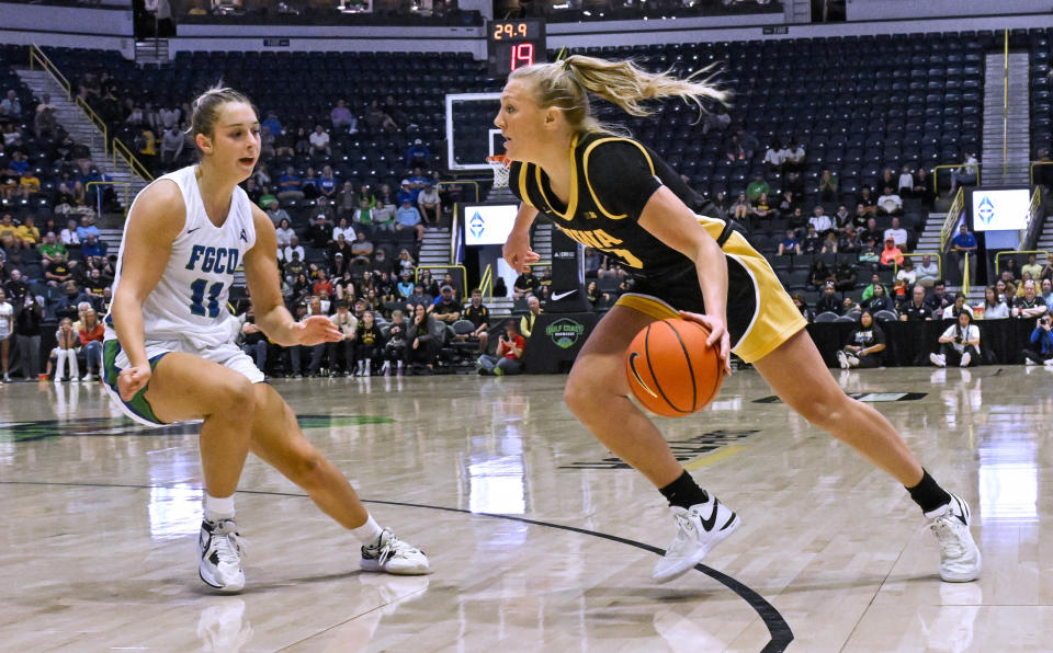 Florida Gulf Coast guard Maddie Antenucci (11) defends against Iowa guard Sydney Affolter (3) during the first half of an NCAA college basketball game in Gulf Coast Showcase, Saturday, Nov. 25, in Estero, Fla. (AP Photo/Steve Nesius)