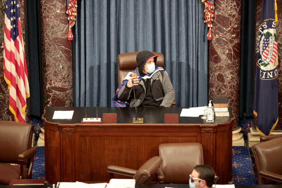 A protester sits in the Senate Chamber on January 06, 2021 in Washington, DC. (Win McNamee/Getty Images)