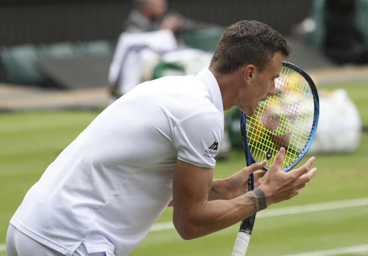 Hungary's Marton Fucsovics celebrates winning a point against Serbia's Novak Djokovic during the men's singles quarterfinals match on day nine of the Wimbledon Tennis Championships in London, Wednesday, July 7, 2021. (AP Photo/Alberto Pezzali)