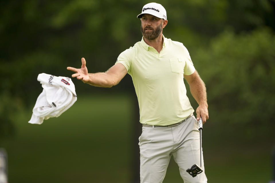 Dustin Johnson tosses his towel to his caddie on the 10th hole during the second round of the PGA Championship golf tournament at Southern Hills Country Club, Friday, May 20, 2022, in Tulsa, Okla. (AP Photo/Matt York)