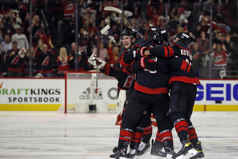 Carolina Hurricanes celebrate an overtime goal by Ian Cole against the New York Rangers in Game 1 of an NHL hockey Stanley Cup second-round playoff series in Raleigh, N.C., Wednesday, May 18, 2022. (AP Photo/Karl B DeBlaker)