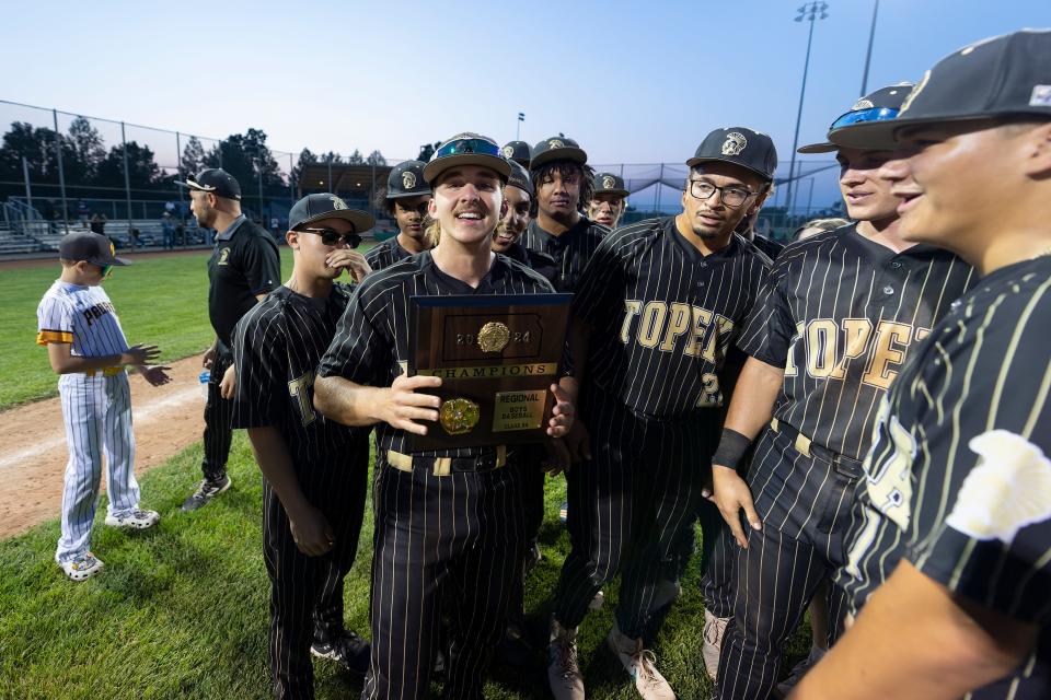 Topeka High’s Nathan Plankinton poses with the trophy Tuesday, May 14, 2024, at Hummer Sports Park.