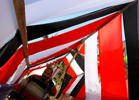 An Egyptian man walks in a school used as a polling station covered from outside by Egyptian flags, during the preparations for the upcoming referendum on constitutional amendments in Cairo, Egypt April 18, 2019. REUTERS/Amr Abdallah Dalsh