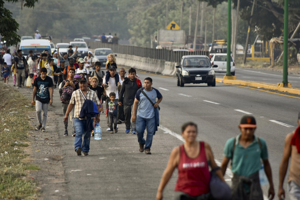 Migrants march to Huehuetan, Chiapas state, Mexico, Monday, April 24, 2023. About 3,000 migrants began walking before dawn for a second day of protest march demanding the end of detention centers like the one that caught fire last month, killing 40 migrants. (AP Photo/Edgar H. Clemente)