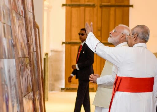 The Archbishop of Colombo, Cardinal Malcolm Ranjith, gives Indian Prime Minister Narendra Modi a tour of one of the Sri Lanka churches hit in the Easter suicide attacks