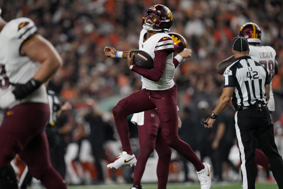 Washington Commanders quarterback Jayden Daniels celebrates after throwing a touchdown pass during the second half of an NFL football game against the Cincinnati Bengals, Monday, Sept. 23, 2024, in Cincinnati. (AP Photo/Carolyn Kaster)