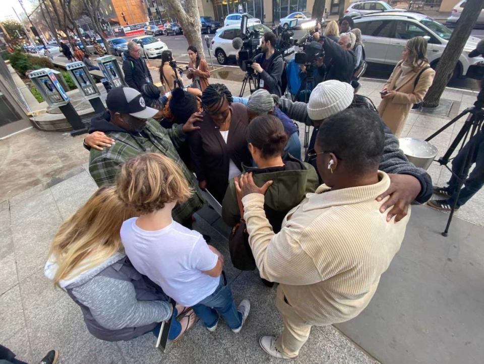 The family and friends of Keith Jhay “KJ” Frierson, 10, pray outside the Sacramento County Main Jail on Wednesday after watching the man accused in KJ’s shooting death appeared in court. The suspect, Arkete Davis, is accused of six counts related to the death of KJ.