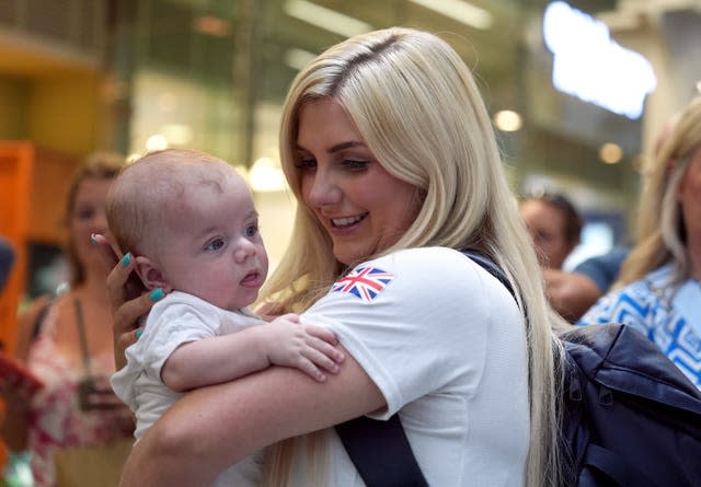 Amber Rutter cuddles her baby son Tommy at a Team GB homecoming event at London St Pancras station