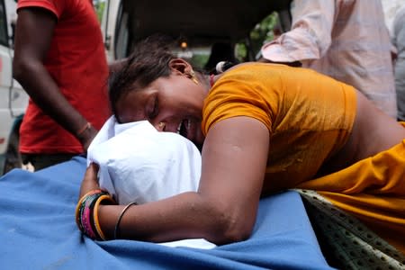 A woman mourns over her daughter's body, who died of acute encephalitis, outside a hospital in Muzaffarpur
