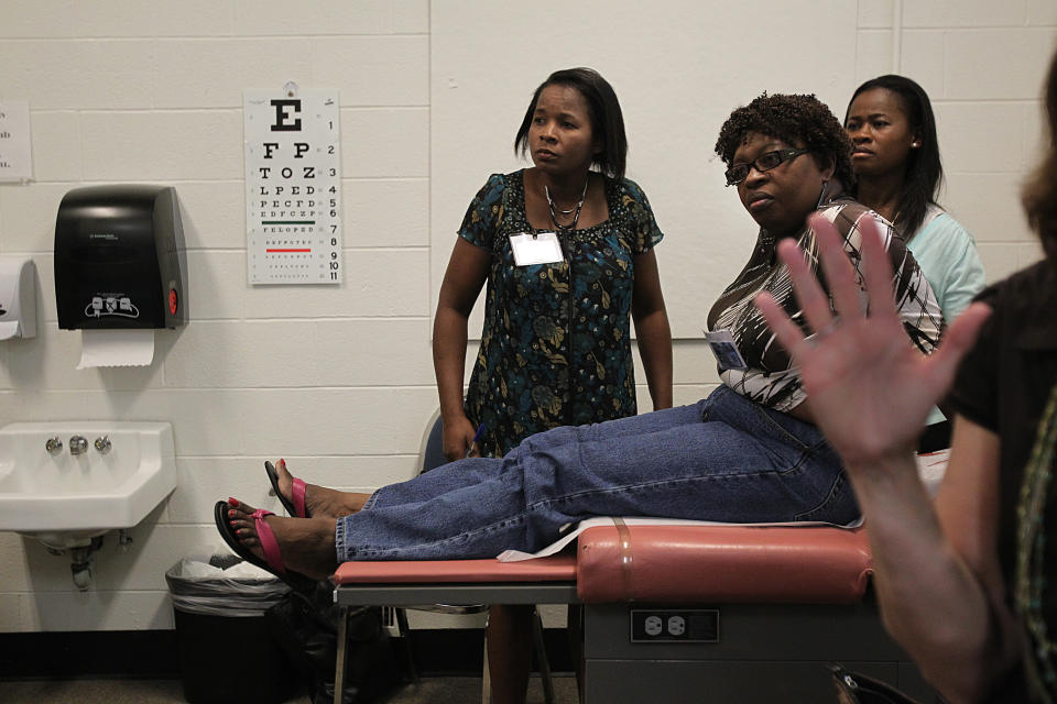 WESTON - JULY 14: Nurses from Haiti attend a training program at Regis College for a few weeks. Left to right, listening in the classroom, student Germaine Laine, Guerda Romelus, and Cherlie Normilus, RN, MSN, FND, Director of Policy and Advocacy with the Regis College International Nurse Faculty Partnership Initiative. (Photo by Suzanne Kreiter/The Boston Globe via Getty Images)