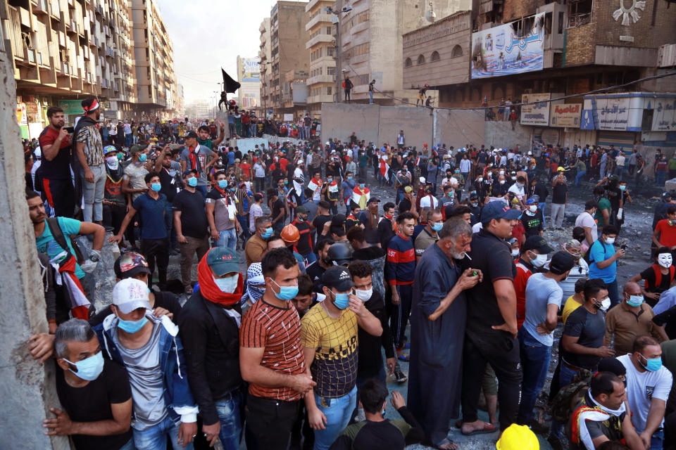 Protesters gather during clashes between Iraqi security forces and anti-Government protesters at Khilani Square in Baghdad, Iraq, Friday, Nov. 15, 2019. (AP Photo/Khalid Mohammed)