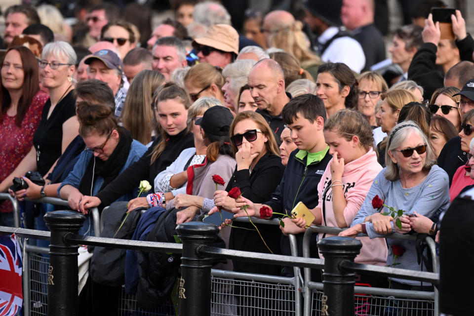 LONDON, ENGLAND - SEPTEMBER 14: Mourners line the streets during the procession for the Lying-in State of Queen Elizabeth II on September 14, 2022 in London, England. Queen Elizabeth II's coffin is taken in procession on a Gun Carriage of The King's Troop Royal Horse Artillery from Buckingham Palace to Westminster Hall where she will lay in state until the early morning of her funeral. Queen Elizabeth II died at Balmoral Castle in Scotland on September 8, 2022, and is succeeded by her eldest son, King Charles III.  (Photo by Leon Neal/Getty Images)