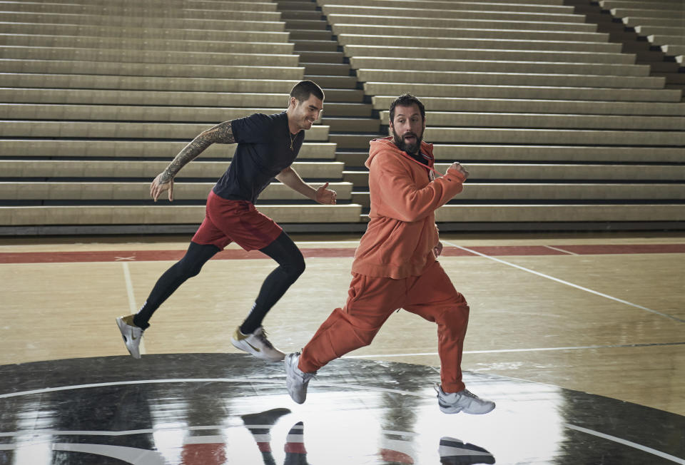 This image released by Netflix shows Juancho Hernangomez and Adam Sandler in a scene from "Hustle." (Scott Yamano/Netflix via AP)