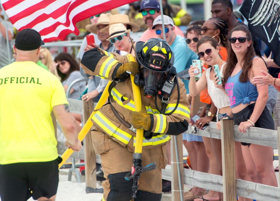 Firefighters compete during a previous Pensacola Beach Firefighters Challenge. This year's event gets underway Friday and Saturday.