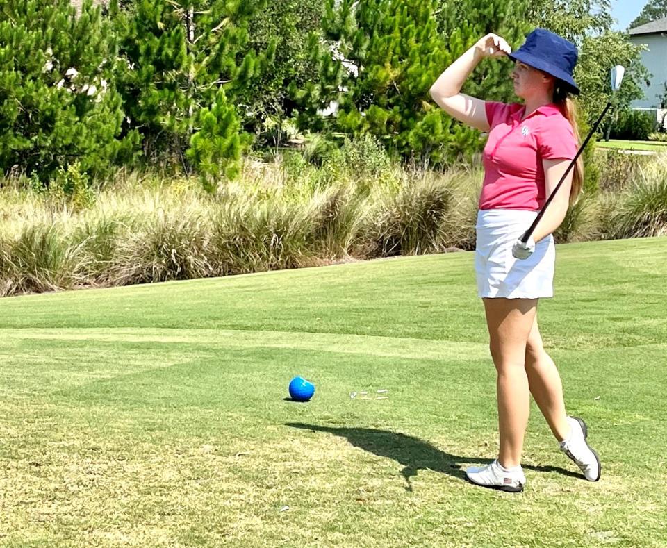 University of North Florida senior Sarah Scott looks through a glaring sun at the track of her tee shot at the par-3 14th hole of the King & Bear on Thursday during the second round of the First Coast Women's Amateur.