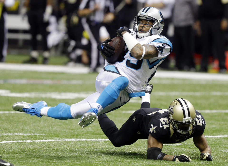 FILE - In this Dec. 3, 2012 file photo, Carolina Panthers' Steve Smith (89) is tripped up by New Orleans Saints' Patrick Robinson (21) after a catch during the second half of an NFL football game in New Orleans. Smith, a free agent, signed a three-year deal with the Baltimore Ravens on Friday, March 14, 2014. (AP Photo/Bill Haber, File)