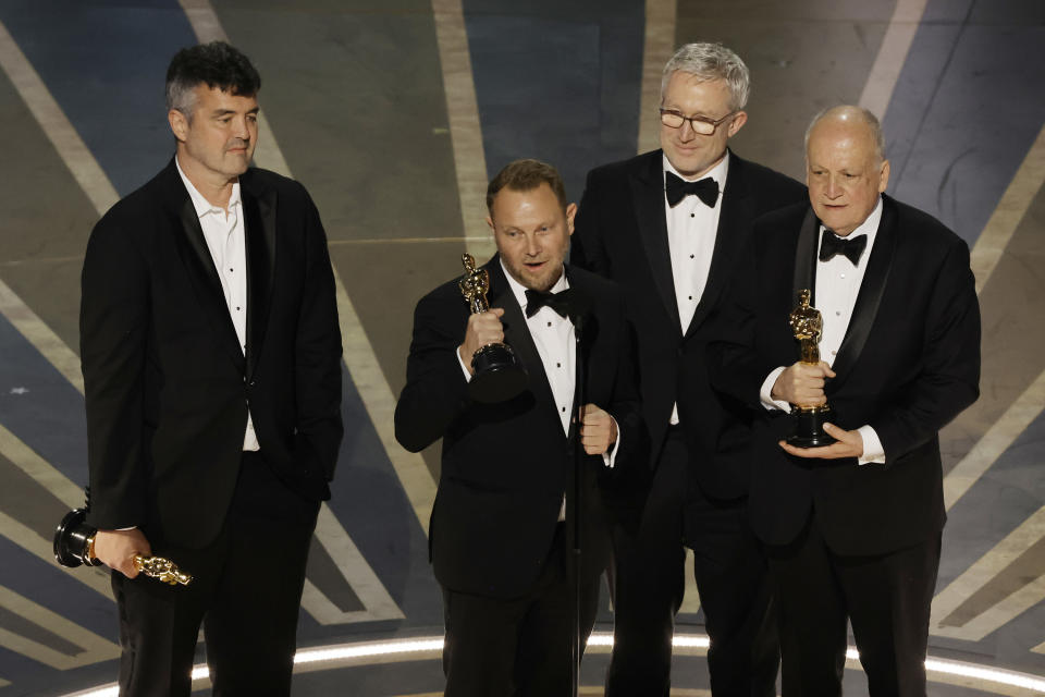 Richard Baneham, Eric Saindon, Daniel Barrett, and Joe Letteri accept Best Visual Effects for Avatar: The Way of Water during the Academy Awards on March 12.